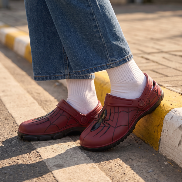 Red web-pattern SYDZ foam clogs worn on a city pavement